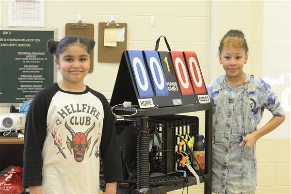 Students Standing Next to Scoreboard